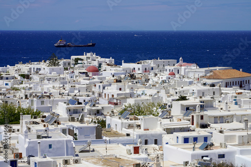 Mykonos touristic destination with traditional whitewashed houses in Greece with blue Mediterranean sea