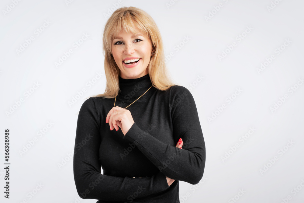 Studio portrait of blond haired woman standing at isolated white background Studio portrait of blond haired woman standing at isolated white background