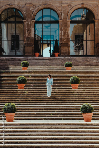female walking down stairs front of Room of the Protomoteca at piazza del Campidoglio ,Rome - Italy
