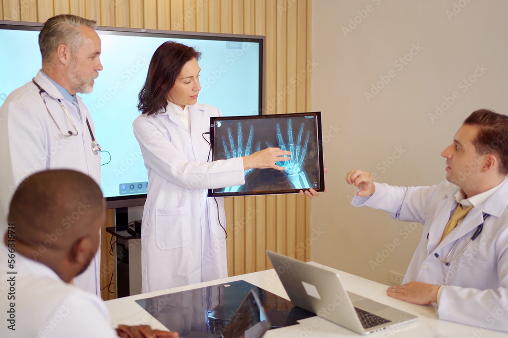 Group of senior executive medication staffs having a discussion in meeting room in hospital, doctors analyzing an X-Ray film.