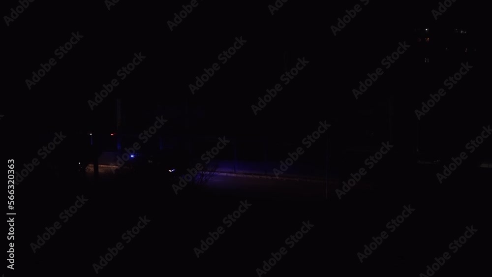 Ambulance moving through the dark streets of the city Ambulance moving through the dark streets of the city