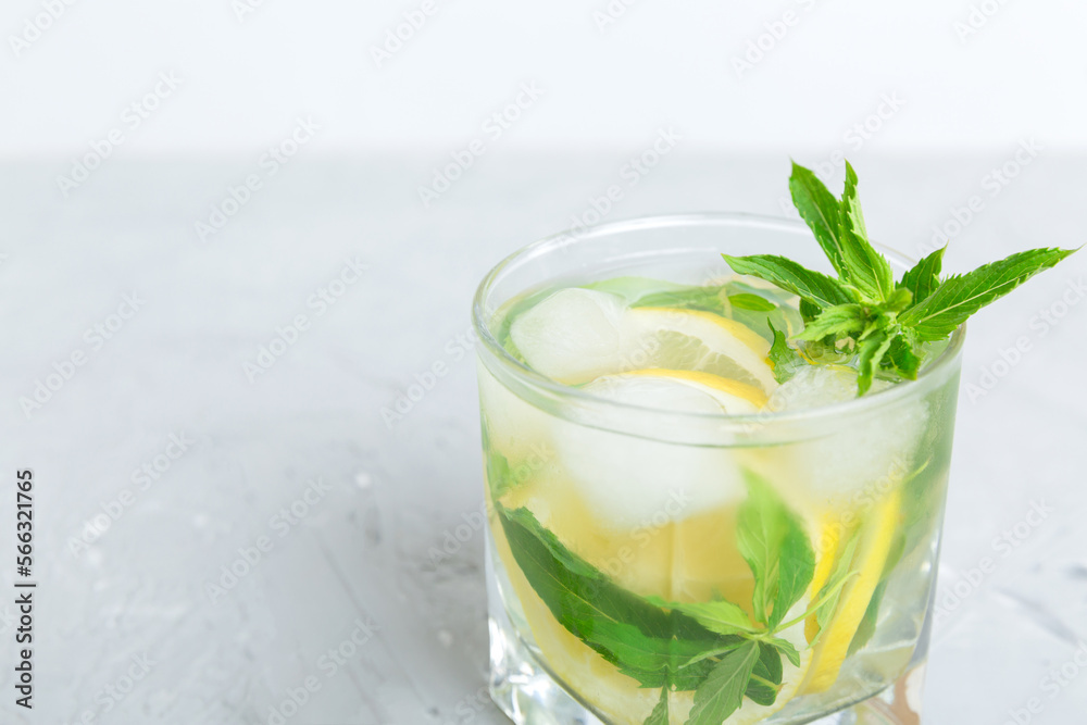 Mojito summer refreshing cocktail with ice and mint. mojito cocktail with lime, lemon and mint in a tall glass with a stick Mojito summer refreshing cocktail with ice and mint. mojito cocktail with lime, lemon and mint in a tall glass with a stick