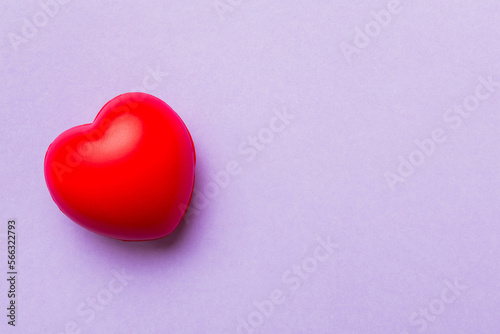 red heart shape on colored background. minimal concept top view with copy space