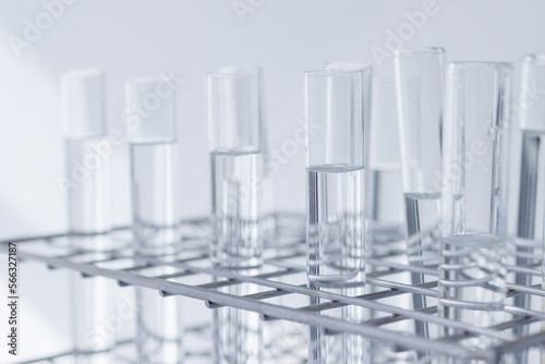 clear substance in scient glass tubes in stainless steel rack on white background. concept: energy fluid labrolatory for education recher and development.