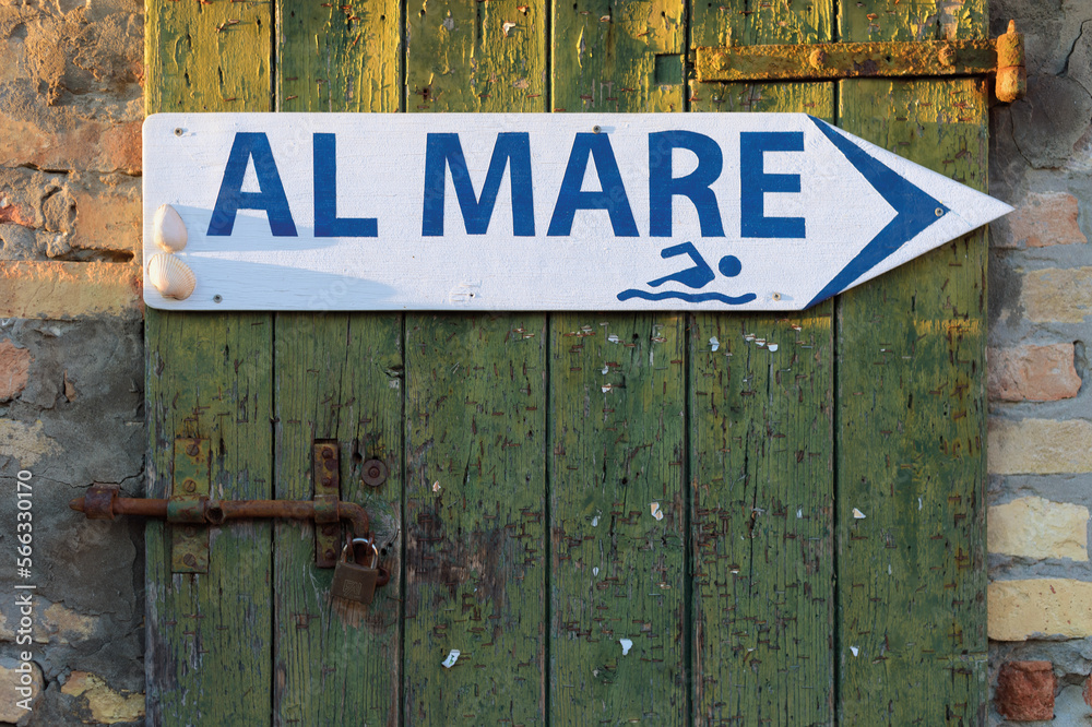 old-wooden-door-and-direction-arrow-sign-pointing-to-the-right-with-the