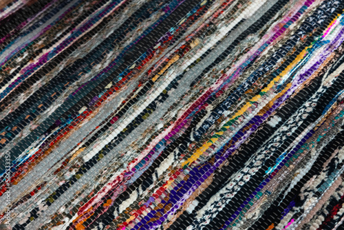 Colorful striped abstract pattern of a knitted carpet, background photo