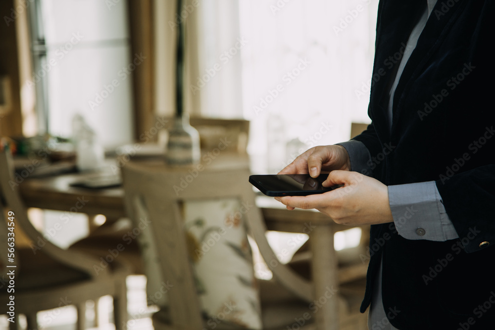 Mature businessman using a digital tablet to discuss information with a younger colleague in a modern business lounge Mature businessman using a digital tablet to discuss information with a younger colleague in a modern business lounge