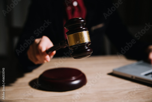 Wallpaper Mural Justice and law concept.Male judge in a courtroom with the gavel, working with, computer and docking keyboard, eyeglasses, on table in morning light Torontodigital.ca