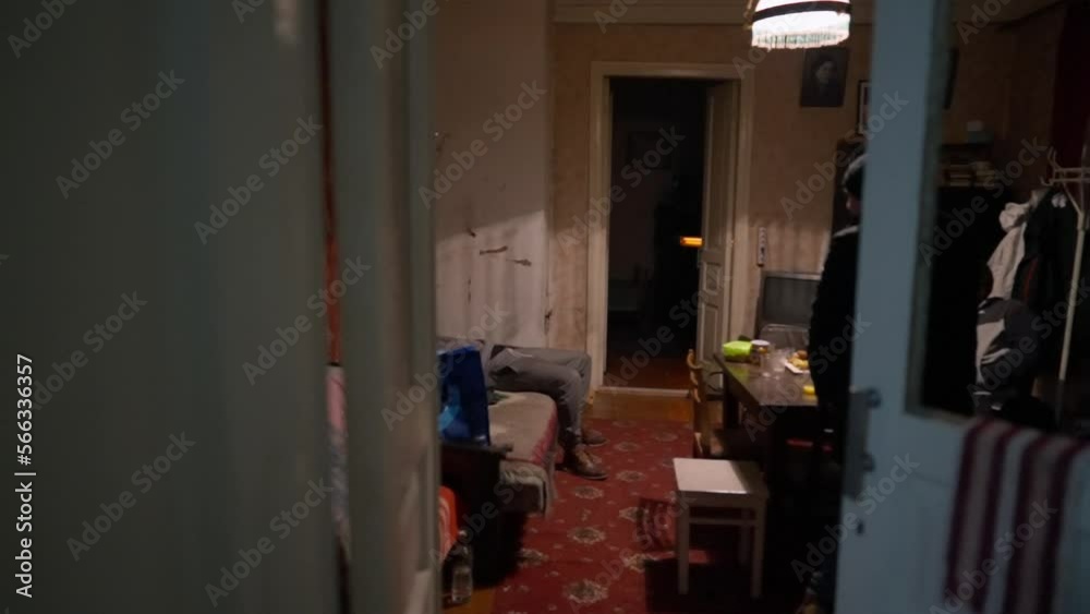Three young men chatting in a dimly lit room Three young men chatting in a dimly lit room