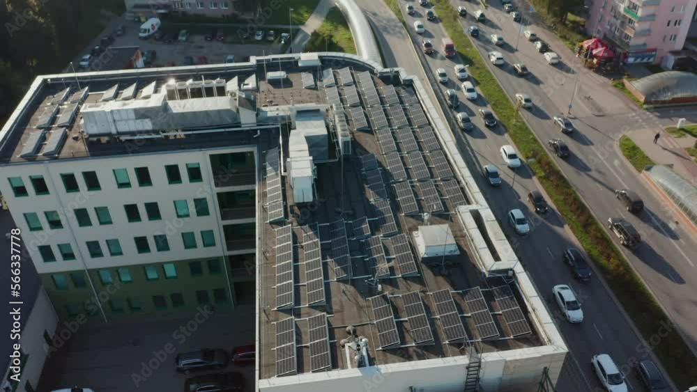 Drone shot on the roof of a residential building with solar panels on it. Photovoltaic solar panels on the roof receive clean energy from the sun. Drone shot on the roof of a residential building with solar panels on it. Photovoltaic solar panels on the roof receive clean energy from the sun.