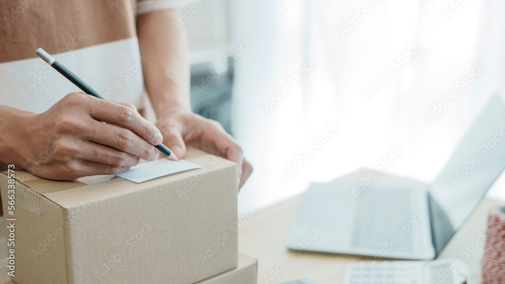 Business owner entrepreneur packing cardboard box preparing parcel for shipment, Online marketing. Business owner entrepreneur packing cardboard box preparing parcel for shipment, Online marketing.