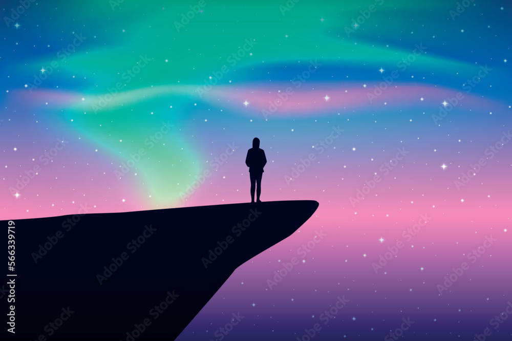 Fototapeta premium girl on a cliff looks in the colorful starry sky with aurora borealis