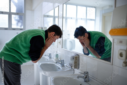 young boy exploring different emotions in front of the mirror