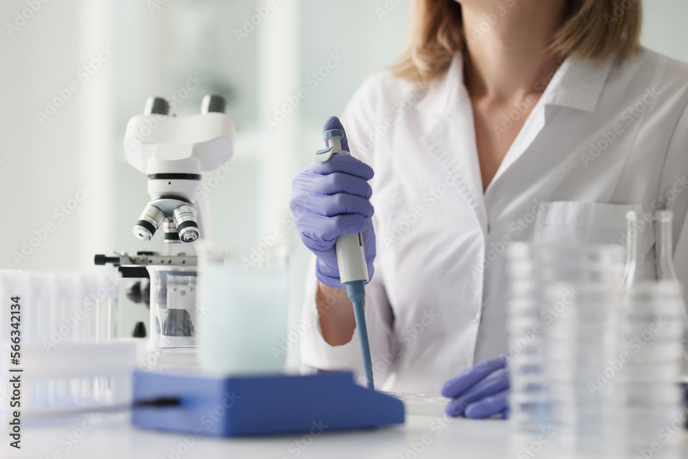 Professional female scientist is working in scientific research laboratory. Professional female scientist is working in scientific research laboratory.