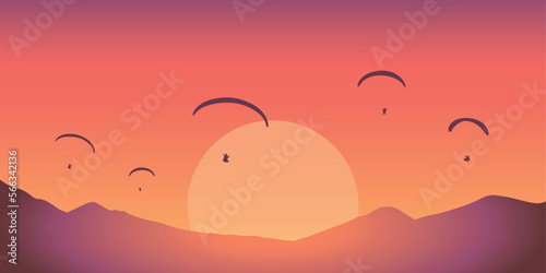 paragliding adventure in the mountains at red sunset