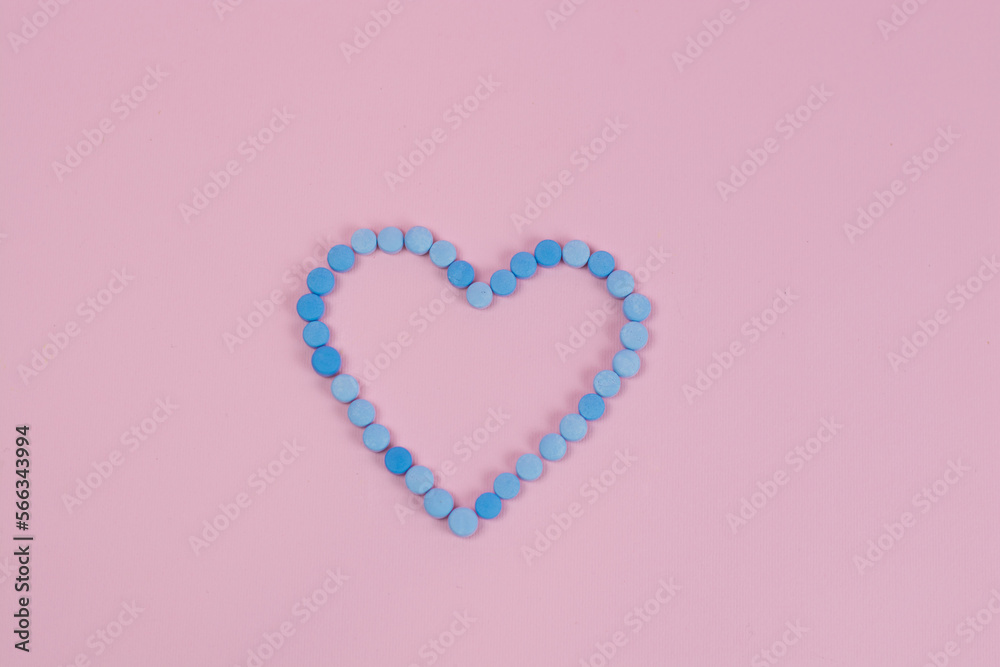 The pills turn into a heart shape on Pink background Isolated Close up Concept of health