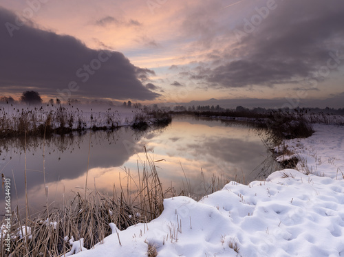 Colorful sunrise over the river in winter