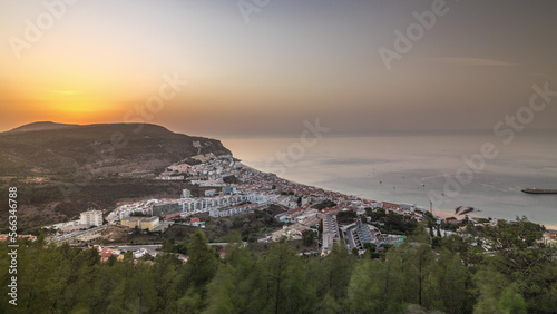 Aerial sunrise view of the coastline of the village of Sesimbra timelapse. Portugal