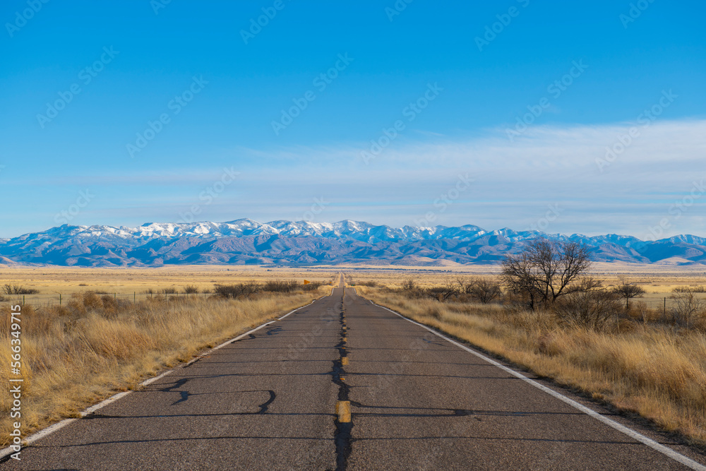 Arizona Route 186 with snow covered Chiricahua Mountains at the background near Chiricahua National Monument in Cochise County in Arizona AZ, USA. 
