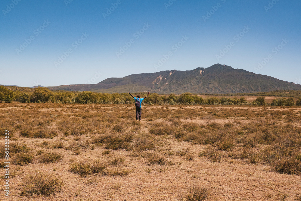 A hiker against the background of Mount Longonot in Naivasha, Kenya
