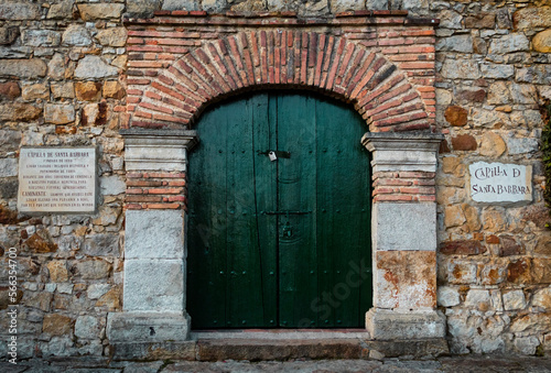 old wooden arch door in a wall