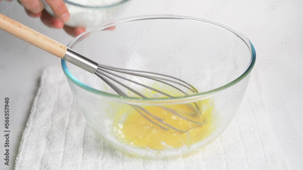 A man moves bowls with ready-made dough and beaten egg white. Cooking in the kitchen. High quality 4k footage A man moves bowls with ready-made dough and beaten egg white. Cooking in the kitchen. High quality 4k footage