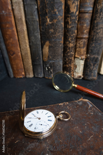 Gold pocket watch "Pavel Bure" on a gold pendant. Royal Russia. pocket watch on a dark background with books 