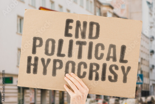 The phrase " End Political Hypocrisy " is on a banner in men's hands with blurred background. Honest. Genuinely. Candid. Open. Transparent. Expose. Investigate. Deceit. Dishonesty. Pretense. Falsehood © AndriiKoval
