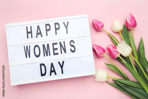 Bouquet flowers of tulips and lightbox with text Happy Women's Day on pink background