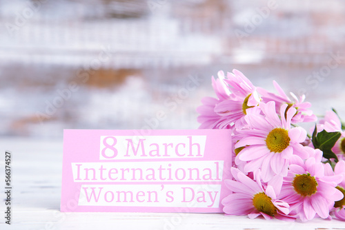 Bouquet flowers of chrysanthemums and card with text 8 march International Women's Day on wooden background