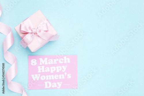 Card with text 8 March Happy Women's Day, ribbon and gift box on blue background