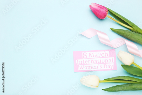 Flowers of tulips, ribbon and card with text 8 march International Women's Day on blue background