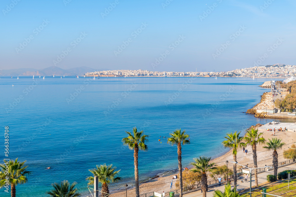Aerial view of the Palaio Faliro waterfront promenade and park with the city of Piraeus Greece in view across the bay, at Palaio Faliro, Greece. - obrazy, fototapety, plakaty 