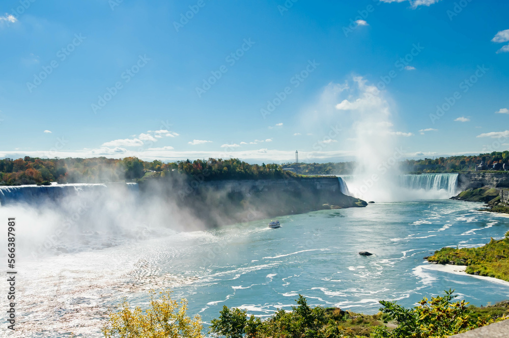 scenic view of Niagara Falls with cruise boat nearby the falls, Ontario, Canada