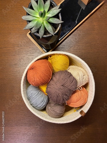 a colorful ball of wool on wooden background