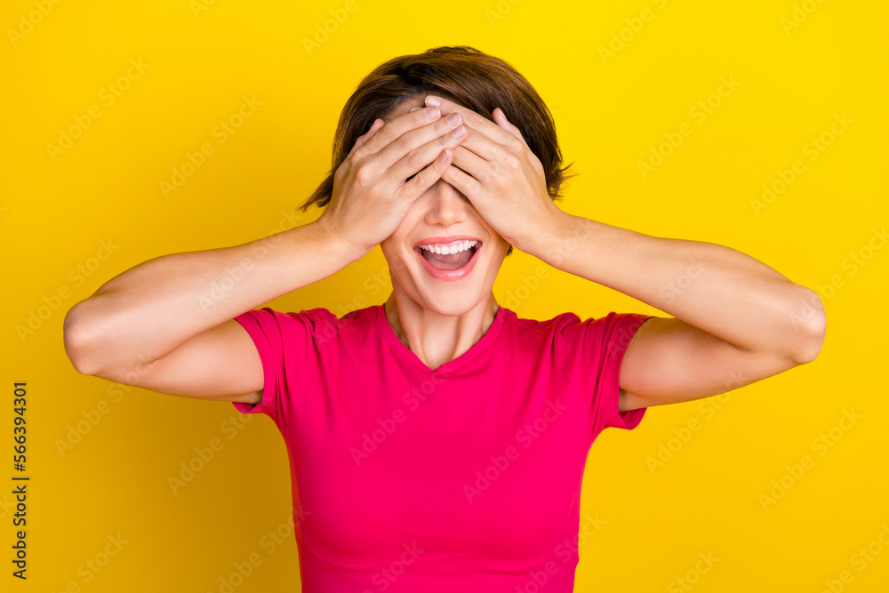 Photo of excited cheerful lady dressed pink clothes arm face have fun isolated on yellow color background Photo of excited cheerful lady dressed pink clothes arm face have fun isolated on yellow color background