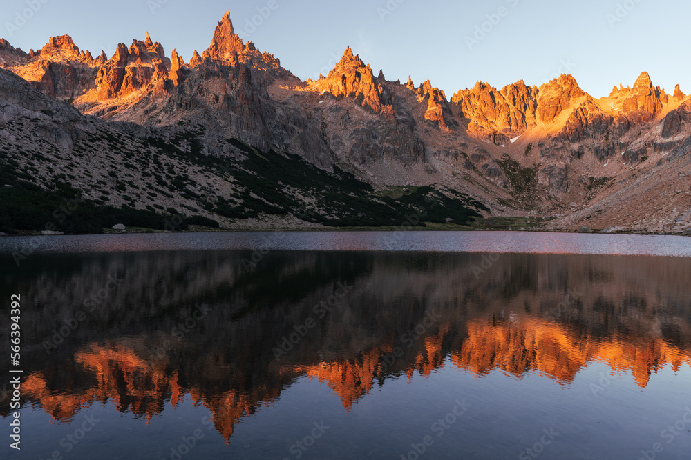 Sunrise reflection on lake landscape over refugio frey in Argentina 