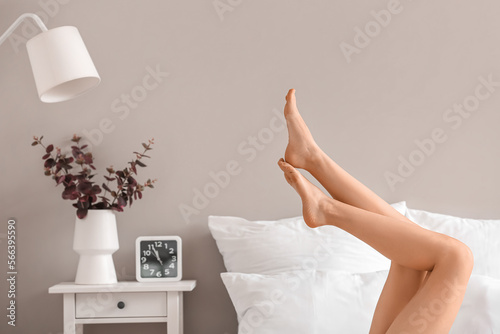 Woman with beautiful legs on bed at home Stock Photo | Adobe Stock