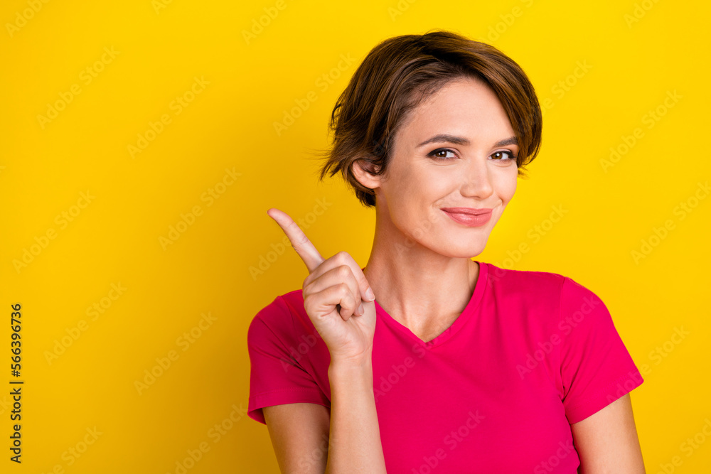 Photo of cheerful positive lady wear pink t-shirt pointing empty space isolated yellow color background Photo of cheerful positive lady wear pink t-shirt pointing empty space isolated yellow color background