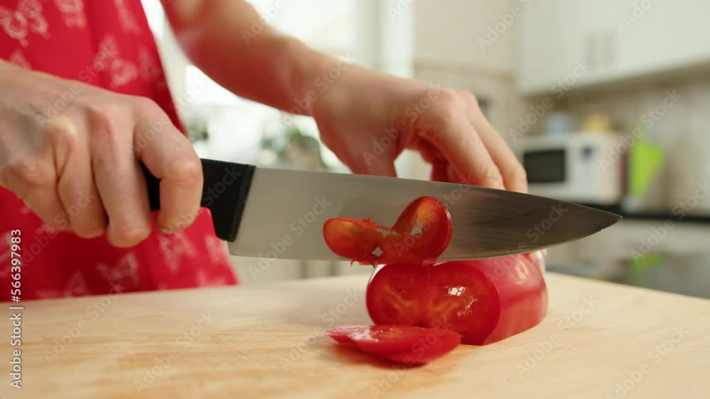Close-up, slow motion of slicing red bell pepper on a cutting board in a home kitchen. High quality 4k footage Close-up, slow motion of slicing red bell pepper on a cutting board in a home kitchen. High quality 4k footage