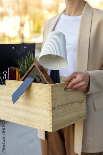 Slika na platnu Woman hands holding the wooden box with personal stuff while going out of the office center