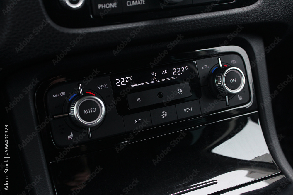 Modern car climate control panel for driver and passenger. Zone climate control. Car interior detail.