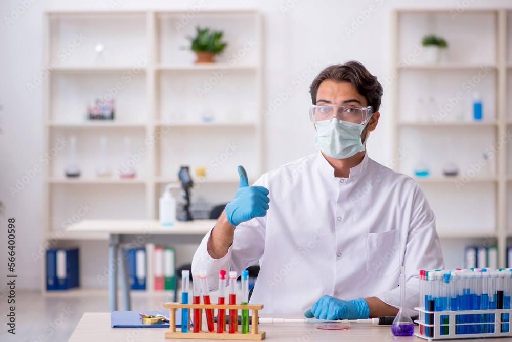 Young male chemist working at the lab Young male chemist working at the lab