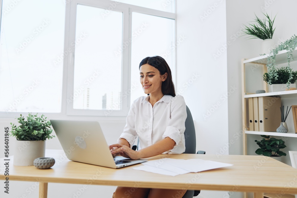 Woman business working at her laptop at home in her office, freelance employee in business, happiness of working online, technology in business Woman business working at her laptop at home in her office, freelance employee in business, happiness of working online, technology in business