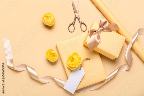 Composition with gift boxes, packing materials and rose flowers on color background. Women's Day celebration