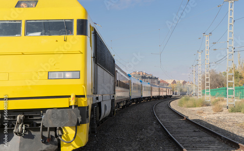 Parked train of yellow color of renfe and railroad track at sight. Madrid. Spain