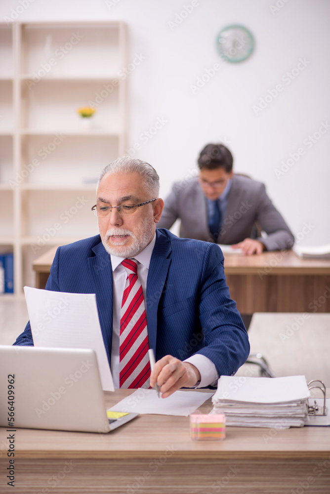 Two male colleagues sitting in the office Two male colleagues sitting in the office