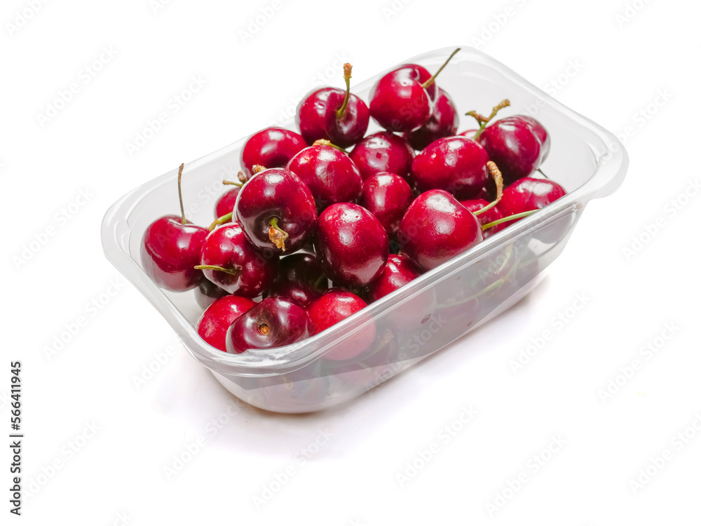 Plastic container full of red ripe cherries on white background. Produce product for sale in a market of shop. Plastic container full of red ripe cherries on white background. Produce product for sale in a market of shop.