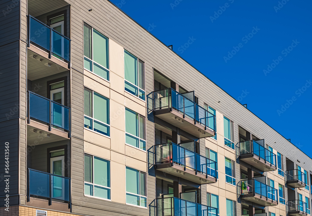 Modern apartment buildings on a sunny day with a blue sky. Facade of a modern apartment building with balconies