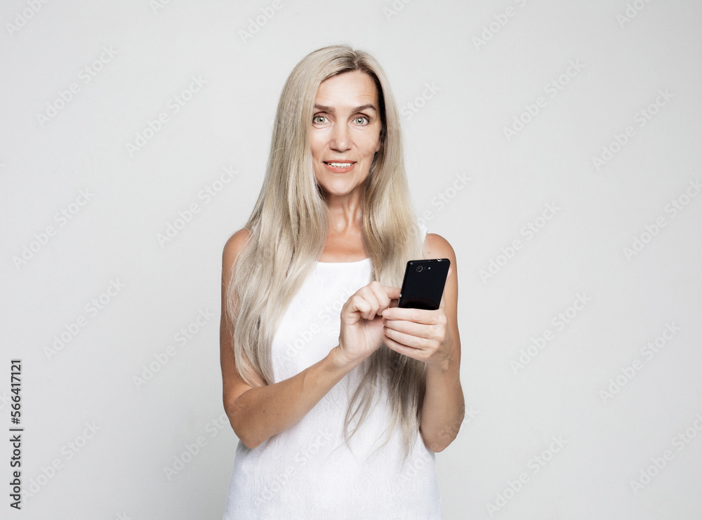 Old people, tehnology and emotion concept: successful old woman with long hair talking on the phone. Old people, tehnology and emotion concept: successful old woman with long hair talking on the phone.